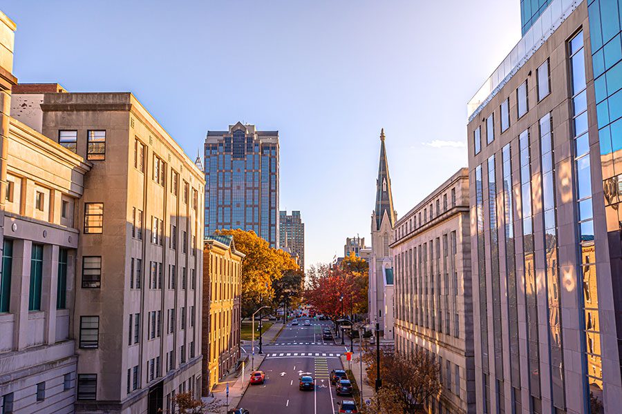 About Us - Raleigh Downtown Buildings at Sunset with Main Street